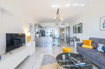 a living room with a couch and a table at RARE! Exquisite 2-bd Apartment Facing the Sea in Cannes