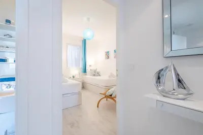 a bathroom with white walls and white furniture at RARE! Exquisite 2-bd Apartment Facing the Sea in Cannes