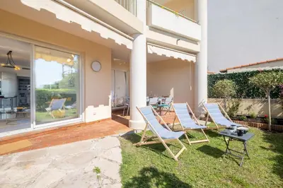a group of chairs and a table on a patio at RARE! Exquisite 2-bd Apartment Facing the Sea in Cannes