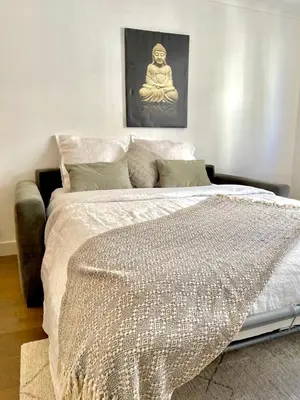 a bedroom with a large bed with a comforter at Studio Ipanema in Cannes