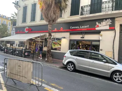 a car parked in front of a store on a street at Studio Ipanema in Cannes
