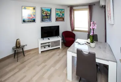 a living room with a desk and a television at Cannes Studio Centre GAMBETTA in Cannes