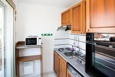 a small kitchen with a sink and a microwave at Cannes Studio Centre GAMBETTA in Cannes
