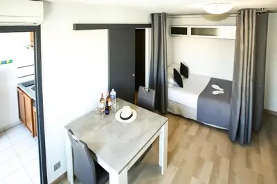 a hotel room with a table and a bed at Cannes Studio Centre GAMBETTA in Cannes