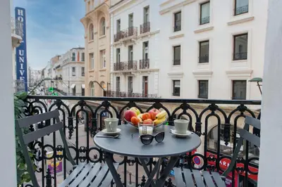 a table with a bowl of fruit on a balcony at Alba apartment antibes street, by Welcome to Cannes in Cannes