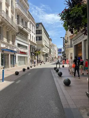 a street in a city with people walking down the street at Alba apartment antibes street, by Welcome to Cannes in Cannes