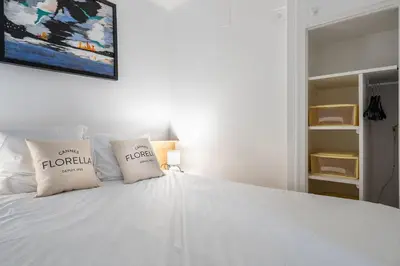 a bedroom with a white bed with two pillows at LE ROYAL Studio adorable avec terrasse, parfait pour les couples et à deux pas de la Croisette in Cannes