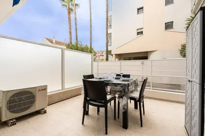 a living room with a couch and a small table at LE ROYAL Studio adorable avec terrasse, parfait pour les couples et à deux pas de la Croisette in Cannes