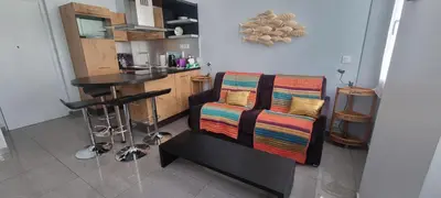 a room with a chair with a table and a kitchen at Cannes Hoche Apartment in Cannes