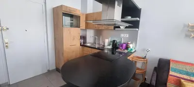 a kitchen with a black table in a room at Cannes Hoche Apartment in Cannes