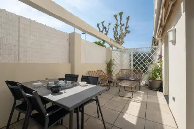 a patio with a table and chairs on a balcony at Comfy apartment with residential swimming pool in Cannes
