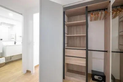a walk in closet with wooden shelves at Comfy apartment with residential swimming pool in Cannes