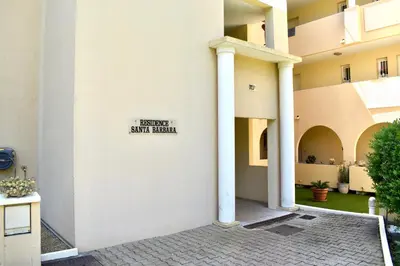 a white building with a sign on the side of it at Magnifique Appartement 2 pièces au calme in Cannes