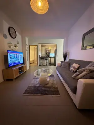 a living room with a couch and a coffee table at Appt lumineux et spacieux au cœur de Cannes in Cannes
