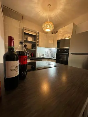 two bottles of wine sitting on a counter in a kitchen at Appt lumineux et spacieux au cœur de Cannes in Cannes