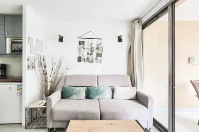 a living room with a couch and a table at Résidence Cannes Villa Francia - maeva Home - Studio 4 personnes - Confort MAE-9944 in Cannes