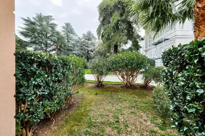 a garden with bushes and trees in front of a building at Résidence Cannes Villa Francia - maeva Home - Studio 4 personnes - Confort MAE-9944 in Cannes