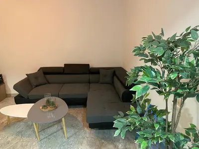 a living room with a couch and a table at bien-être in Cannes