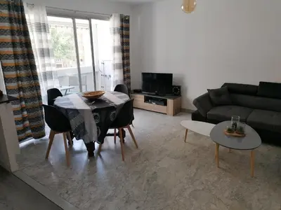 a living room with a table and a couch at bien-être in Cannes