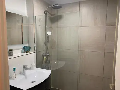 a bathroom with a shower with a sink and a mirror at bien-être in Cannes