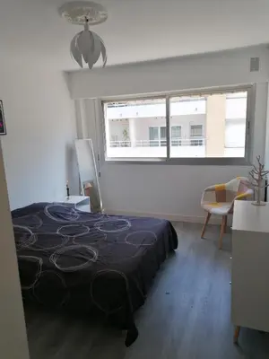 a white room with a bed and a window at bien-être in Cannes