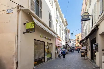 a street in a city with people walking down the street at Cannes Hyper Centre climatisé in Cannes