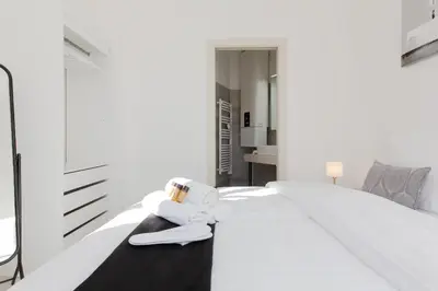 a bedroom with a white bed with a towel on it at Anzur YourHostHelper in Cannes