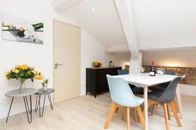a dining room with a white table and chairs at Anzur YourHostHelper in Cannes
