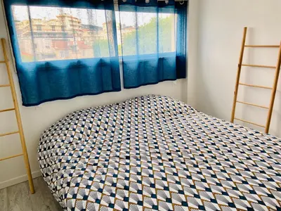 a bed in a room with a window at Appartement T3 , 650m du Palais des Festivals in Cannes