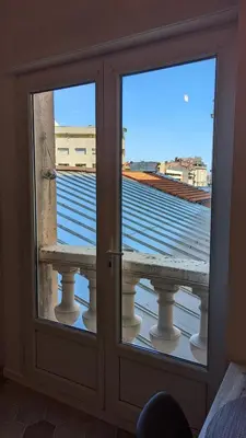 two glass doors with a view of a balcony at Appartement T3 , 650m du Palais des Festivals in Cannes