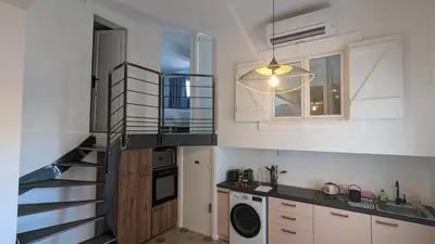 a kitchen with a staircase and a laundry room at Appartement T3 , 650m du Palais des Festivals in Cannes