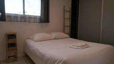 a bedroom with a bed with two towels on it at Appartement T3 , 650m du Palais des Festivals in Cannes