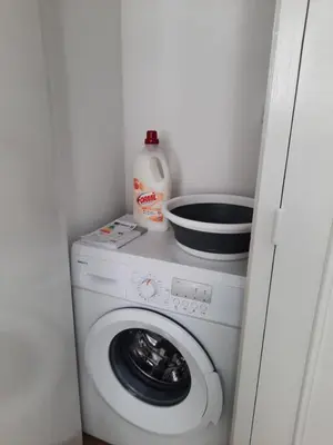 a washing machine with a bowl on top of it at T2 neuf, balcon, centre Cannes, 15 min du Palais in Cannes