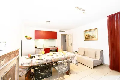 a kitchen and living room with a table and a couch at The Old Port chez Antonella in Cannes