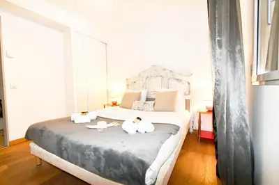 a bedroom with a bed with two towels on it at The Old Port chez Antonella in Cannes