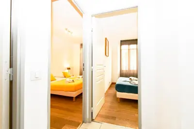 a bedroom with two beds and a mirror at The Old Port chez Antonella in Cannes