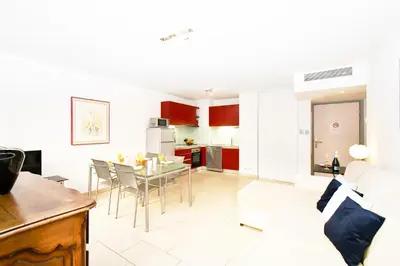 a kitchen and living room with a table and chairs at The Old Port chez Antonella in Cannes