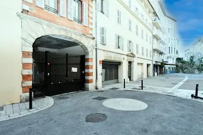an entrance to a building with a black gate at The Old Port chez Antonella in Cannes