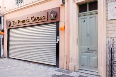 a building with a garage door and a sign on it at Lumière YourHostHelper in Cannes