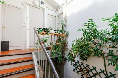 a staircase with plants on the wall at Lumière YourHostHelper in Cannes