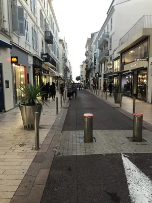 an empty city street with people walking down the street at Centre heart of CAnnes in Cannes