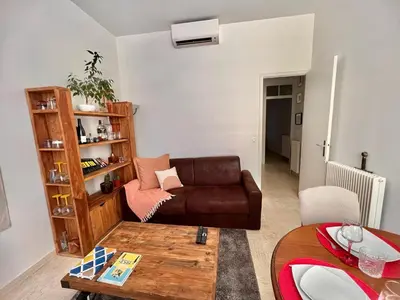 a living room with a couch and a table at Centre heart of CAnnes in Cannes