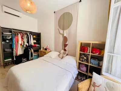 a bedroom with a white bed and a mirror at Centre heart of CAnnes in Cannes
