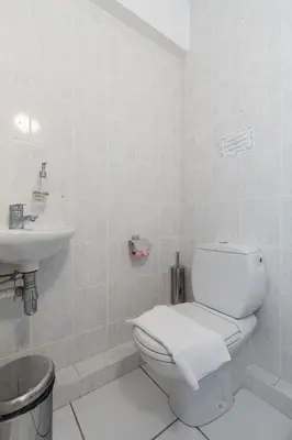 a white bathroom with a toilet and a sink at Bright two bedroomed apartment on the beach in Cannes with huge terrace with fabulous sea views - 2001 in Cannes