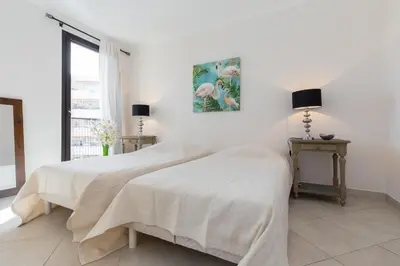 two beds in a room with white walls at Modern 3 bedroom 3 bathroom apartment for rent near Cannes Old Town walking distance to Palais - 2000 in Cannes