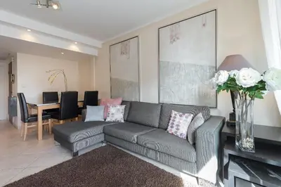 a living room with a gray couch and a table at Modern 3 bedroom 3 bathroom apartment for rent near Cannes Old Town walking distance to Palais - 2000 in Cannes
