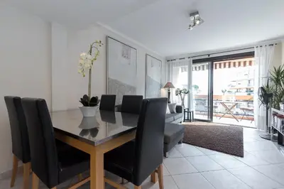 a dining room with a table and black chairs at Modern 3 bedroom 3 bathroom apartment for rent near Cannes Old Town walking distance to Palais - 2000 in Cannes