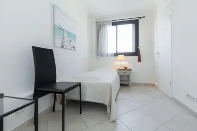 a bedroom with a bed and a chair and a window at Modern 3 bedroom 3 bathroom apartment for rent near Cannes Old Town walking distance to Palais - 2000 in Cannes