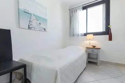 a white bedroom with a bed and a window at Modern 3 bedroom 3 bathroom apartment for rent near Cannes Old Town walking distance to Palais - 2000 in Cannes