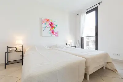 a white bedroom with a large bed and a window at Modern 3 bedroom 3 bathroom apartment for rent near Cannes Old Town walking distance to Palais - 2000 in Cannes